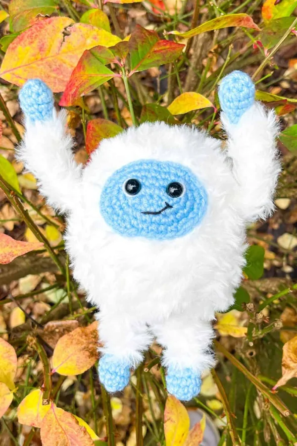 A fluffy crochet yeti plushie.