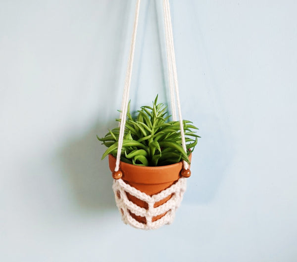 Chevron-patterned crochet plant hanger.