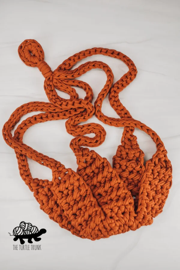 A flat lay image of an empty crochet plant hanger.