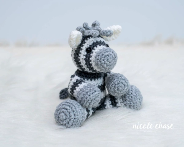 A sitting crochet zebra toy.